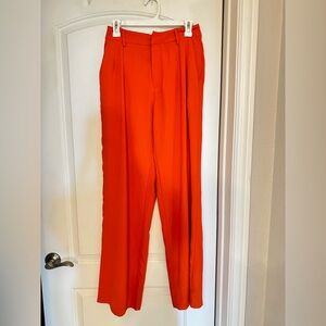 Light red/orange dress pants. Never been worn, still with tags.. Medium.